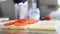 Hands prepare a cheese and tomato sandwich
