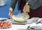 Hands preparing cream, chef whisking cream in kitchen