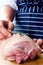 Hands preparing raw meat for roast meal