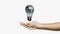Hands presenting light bulb with earth
