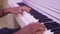 Hands of professional african american musician playing on piano, close-up view.