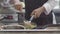 Hands of professional chef stirs spaghetti on a pan. Cook works in a modern kitchen with lots of ingredients. 3840x2160