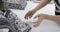 Hands of a professional dressmaker ironing snoods, the process of sewing clothes in a sewing workshop.