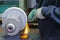 Hands of Professional Fitter Man Using Metal Polishing MAchine for Metal Rods Sharpening With Plenty of Sparks