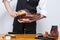 Hands of Professional Male Shoes Cleaner with Cleaning Brushes For Tan Derby Leather Boots While Working in Workshop