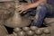 Hands of Professional Thai man using mechanic pottery made earthenware at `Koh Kret` in Thailand