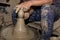 Hands of Professional Thai man using mechanic pottery made earthenware at `Koh Kret` in Thailand