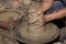 Hands of Professional Thai man using mechanic pottery made earthenware at `Koh Kret` in Thailand