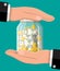 Hands protects glass jar with gold coins banknotes