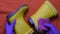 Hands in purple rubber gloves clean kids yellow rubber boots