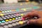 Hands push a button of Switcher buttons in studio TV station, Au