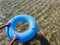 Hands pushing a donut inflatable in the sea