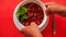 Hands Put Bowl of Ukrainian Soup Borsch to Plate on Red Table