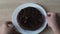 Hands putting chocolate cake with cherry on top on wooden table, birthday