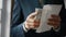 Hands putting dollars envelope close up. Man holding banknotes american currency