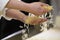 Hands of quality control manager controlling the quality of the raw macaroni - food factory