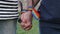 Hands with rainbow LGBT ribbons on the wrists. gay couple gently holds hands