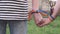 Hands with rainbow LGBT ribbons on the wrists. gay couple gently holds hands