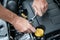 Hands repairing a car engine with a wrench