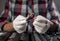 Hands of repairman in gloves close up with metal steel socket ratchet handle over toolkit