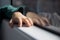 Hands resting on a resting surface in a window with reflection