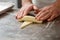 Hands rolling dough into croissants