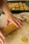 Hands rolling a dough shape for the cookie