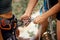 Hands, safety and rock climbing a mountain with a climber securing ropes for abseiling or scaling mountains outdoor in