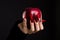 Hands with scary nails manicure holding red apple