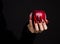 Hands with scary nails manicure holding red apple