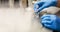 Hands of a scientist in the laboratory with a test tube and a microscope. The invention of the vaccine, a doctor in the clinic of