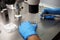 Hands of a scientist in the laboratory with a test tube and a microscope. The invention of the vaccine, a doctor in the clinic of