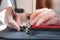 Hands of a seamstress doing precise work, close-up view.