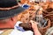 Hands of the senior craftsman while weaving wicker basket. Traditional Slovak folk craft