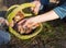 hands of several people hold basket with freshly picked forest mushrooms