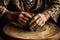 hands shaping clay on a pottery wheel