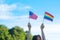 Hands showing LGBTQ Rainbow and America flag on nature background. Support Lesbian, Gay, Bisexual, Transgender and Queer community