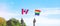 Hands showing LGBTQ Rainbow and Canada flag on nature background. Support Lesbian, Gay, Bisexual, Transgender and Queer community