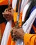 Hands of a Sikh senior man who hold the sword during religious f