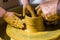 hands of the skilled master Potter and children\'s hands, training of the kid to production of pottery on a Potter\'s wheel