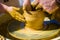 hands of the skilled master Potter and children\'s hands, training of the kid to production of pottery on a Potter\'s wheel