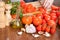 Hands slicing tomatoes at table