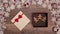 Hands slipping a christmas present box inside a seasonal decorations frame