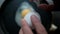 Hands slowly cracking an egg into frying pan