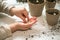 Hands of a small child planted seeds at home. Seeds of courgette or pumpkin in open palm of child. Earth day concept