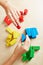 Hands sorting building blocks by color