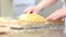 Hands spread cream on puff pastry