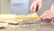 Hands spread cream on puff pastry