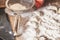 Hands sprinkle with flour raw dumplings on table