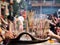 Hands stab Incense sticks on joss stick pot burning and smoke used to pay respect to Buddha
